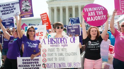 large crowd of women holding signs supporting abortion rights in front of Supreme Court