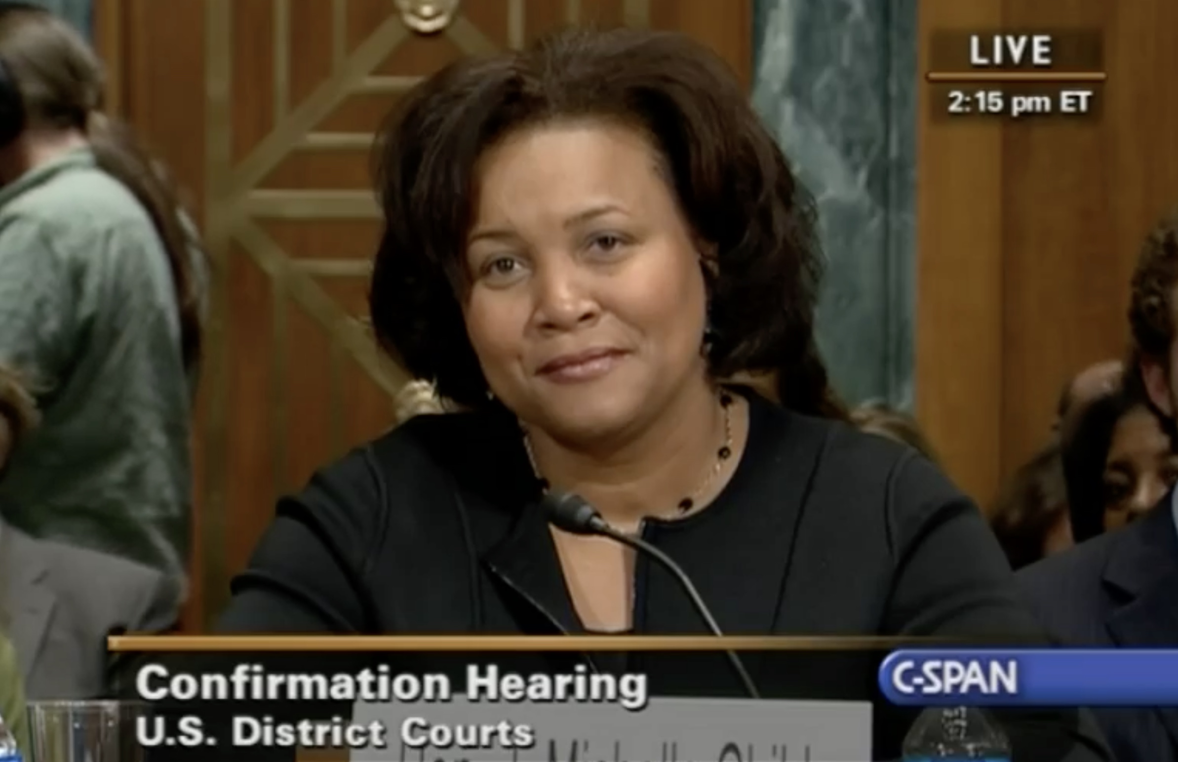 woman speaking at microphone in congressional hearing room
