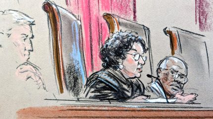 Justice Sotomayor speaking from the bench while Justice Thomas looks on.