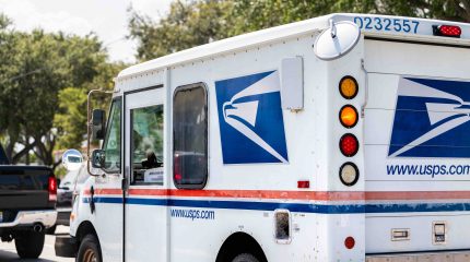 U.S. Postal Service van in traffic