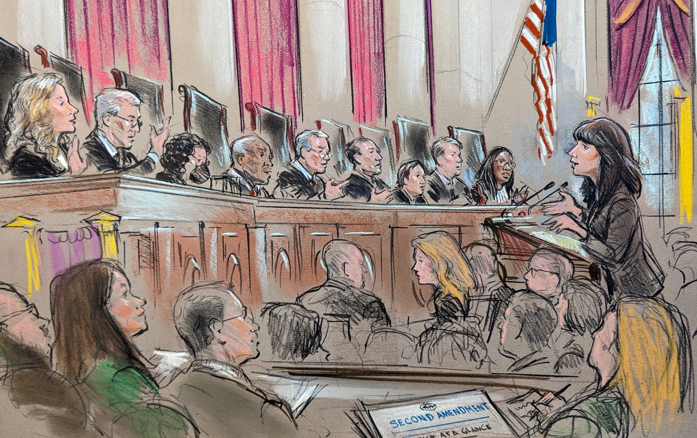 Woman speaking to all nine justices in front of a crowd of listeners and journalists