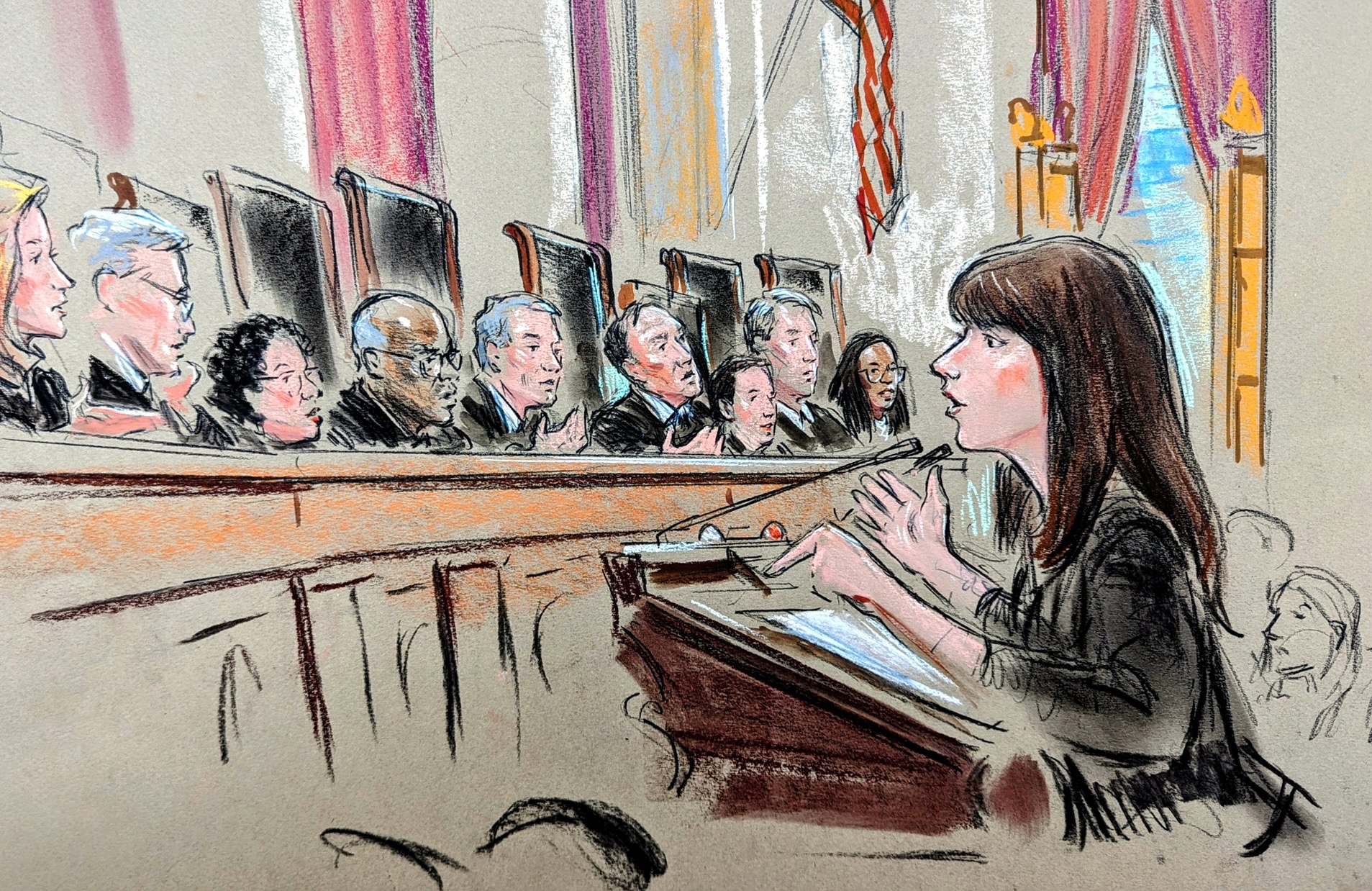 Woman speaking to bench of justices