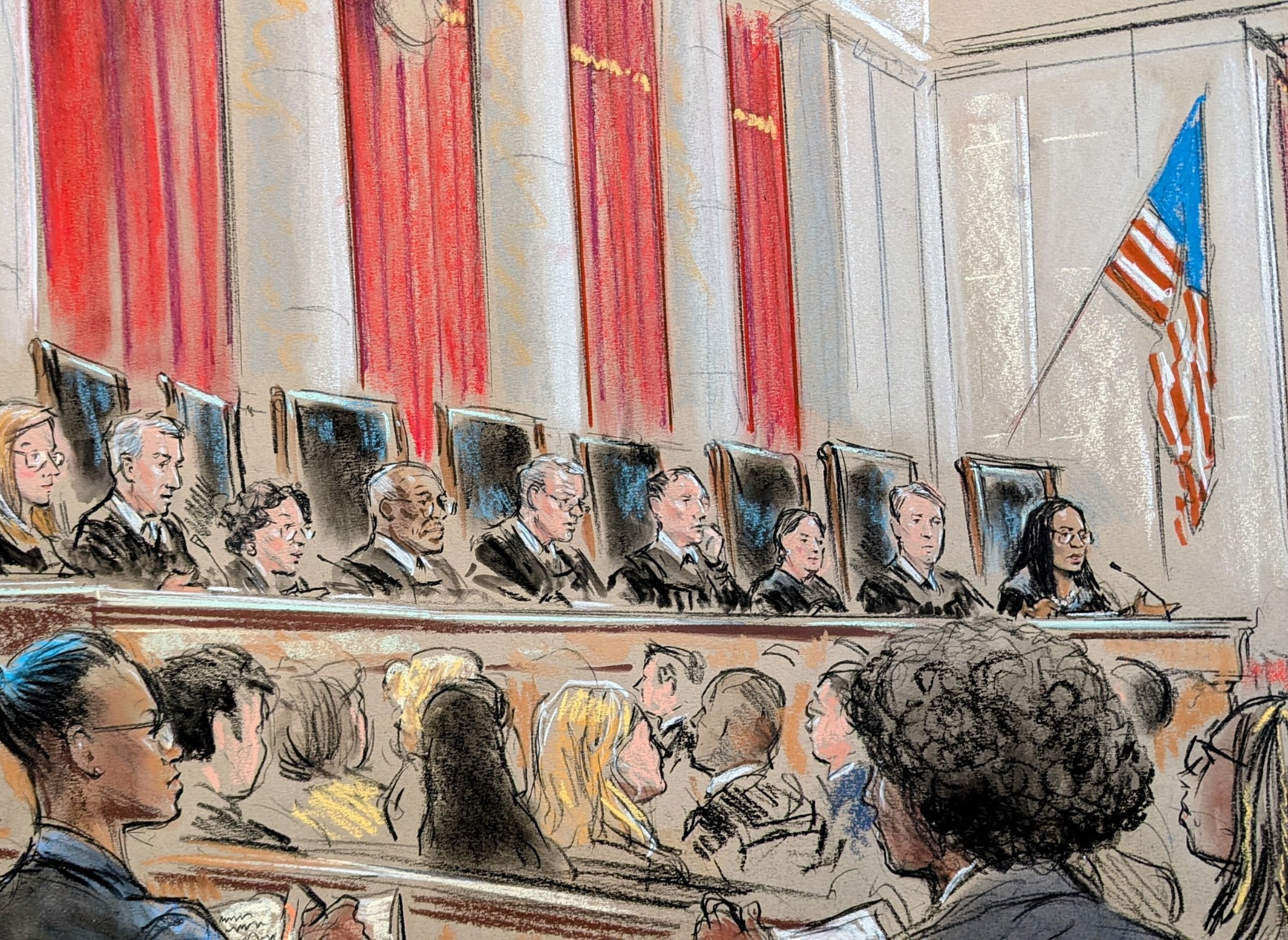 Nine justices on the bench speaking to a listening courtroom