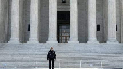 Police officer standing on Supreme Court steps