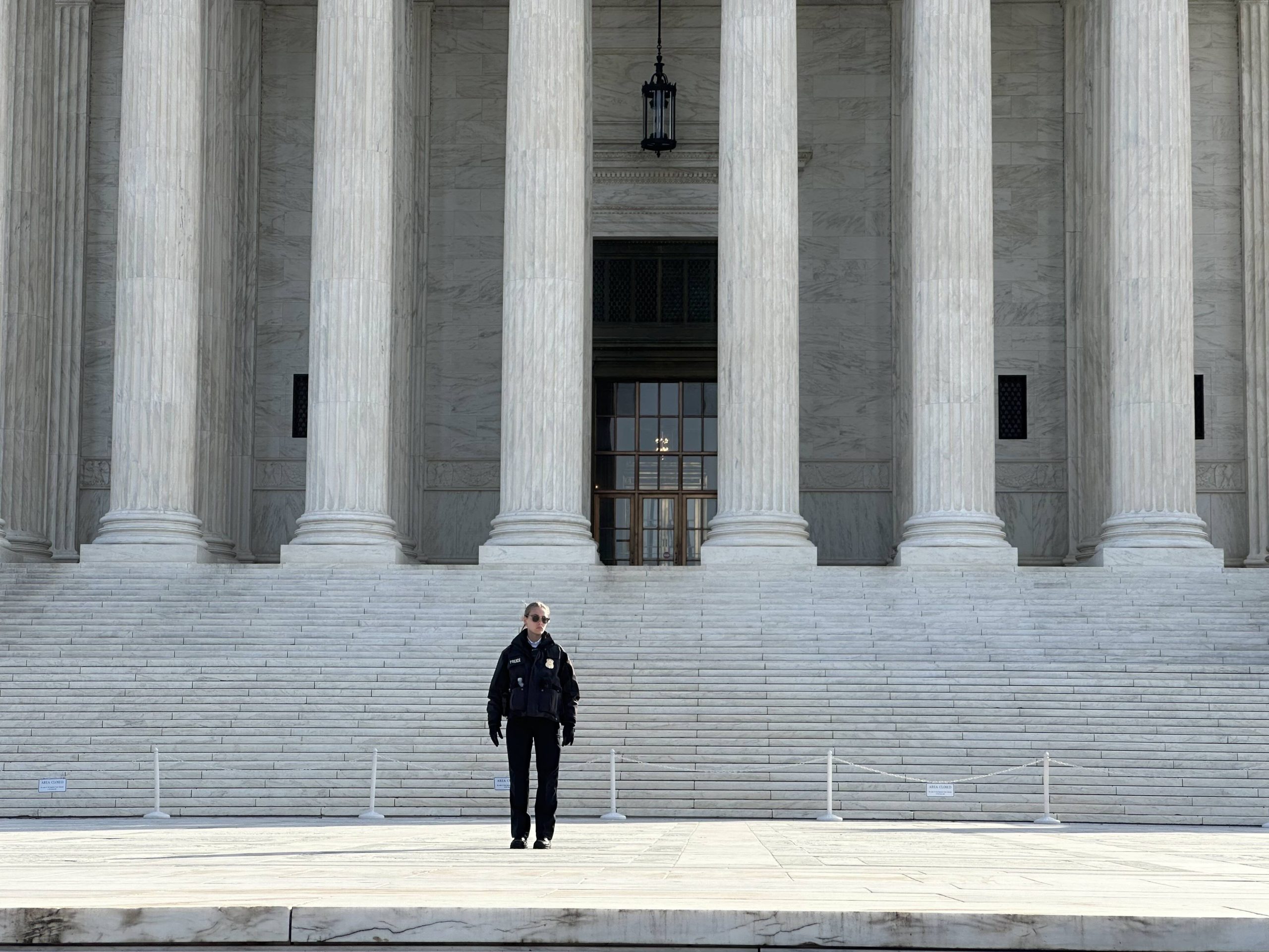 Police officer standing on Supreme Court steps