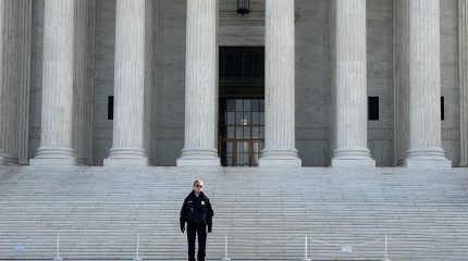 Police officer in front of court