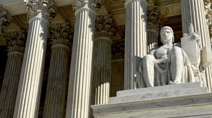 The columns and statute in front of the Supreme Court