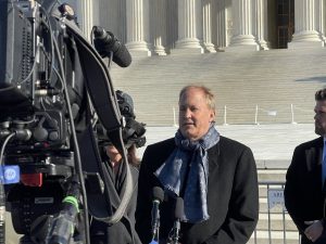 Man speaking before camera