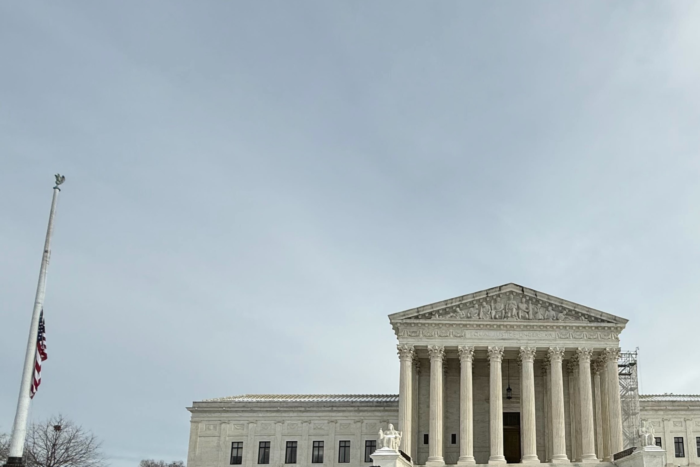 The Supreme Court building and American flag