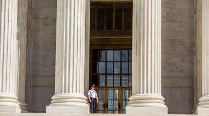 Guard standing on the Supreme Court steps